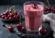 Bebida de kéfir con cerezas servida en vasos, bebida cremosa de color rosa pálido con trozos de cereza